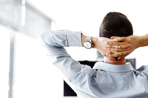 Young businessman sitting at desk in office