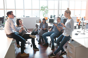 Group of a young business people discussing business plan  in the office