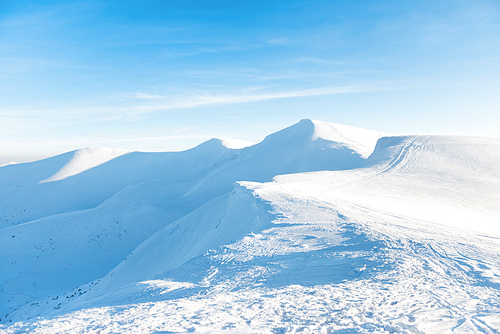 Beautiful winter landscape with snow mountains under blue sky