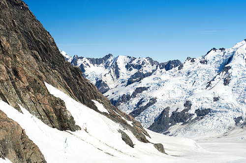 Natural mountain landscape with snow and clear blue sky