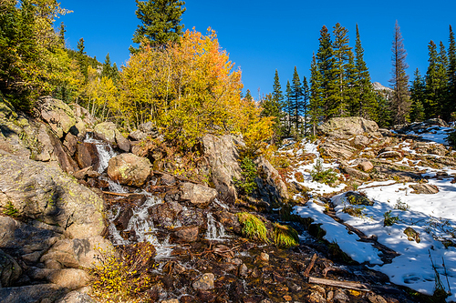 Season changing, first snow and autumn aspen trees in  Rocky Mountain National Park, Colorado, USA.