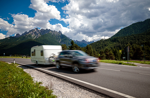 Family vacation travel, holiday trip in motorhome RV, Caravan car Vacation. Beautiful Nature Italy natural landscape Alps. Warning - authentic shooting there is a motion blur.