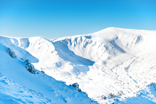 Range of mountains peaks in snow. Winter landscape