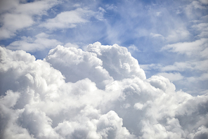 Stormy cumulus clouds with high level cirrocumulus clouds for use as background