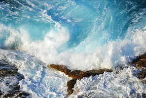foam  waves splash at stones on shore sea