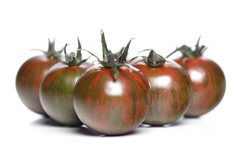 Black cherry tomatoes on white background