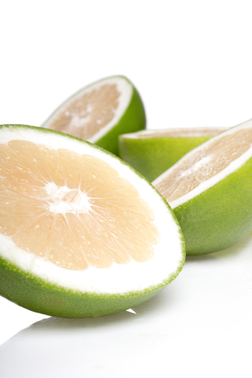 Green grapefruits on white background