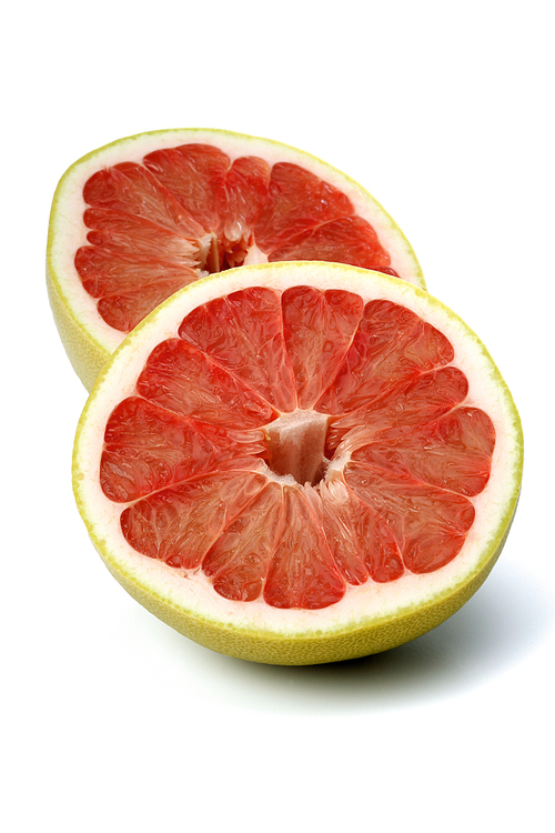 Halved grapefruit on white background