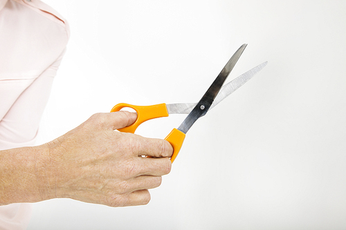 Close-up view of senior businesswoman holding scissors