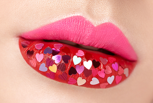 beautiful plump pink lips with pasted hearts. beauty  lips with red lipstick. valentine's day. beautiful love make-up