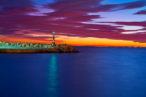 Alicante Cabo Las Huertas beacon light at sunset on Pier Spain