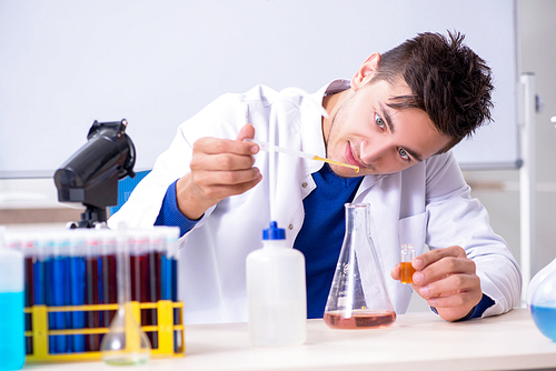 Young chemist sitting in the lab