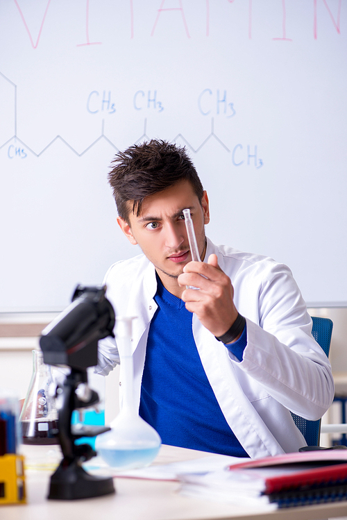 Young chemist sitting in the lab