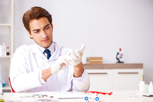 Young expert criminologist working in the lab