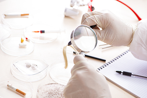 Young expert criminologist working in the lab