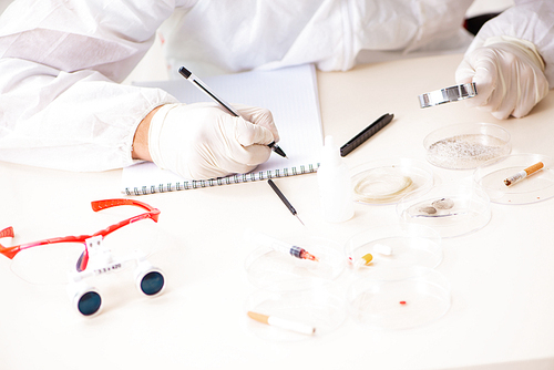 Young expert criminologist working in the lab