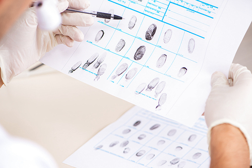 Forensic expert studying fingerprints in the lab