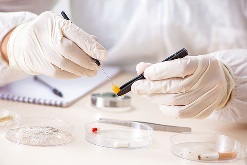 Young expert criminologist working in the lab