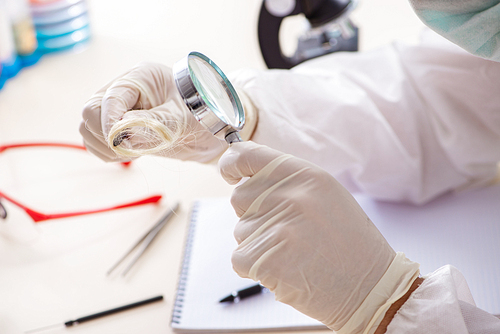 Young expert criminologist working in the lab