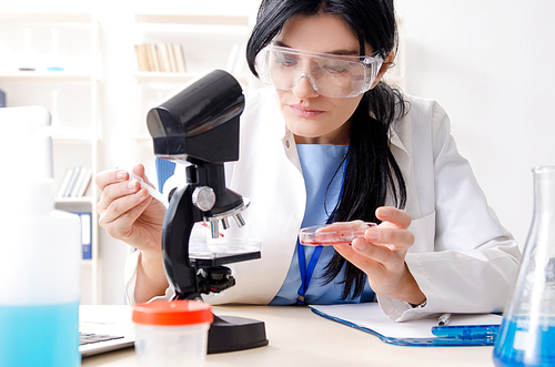 Female chemist working at the lab