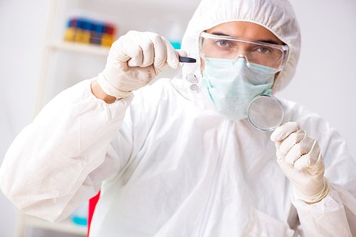 Young expert criminologist working in the lab