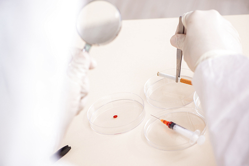 Young expert criminologist working in the lab