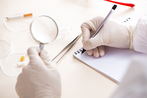 Young expert criminologist working in the lab