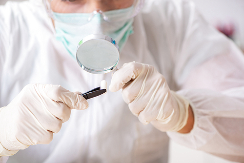 Young expert criminologist working in the lab