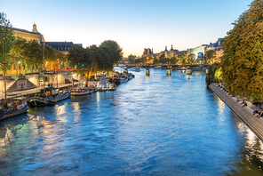 Paris at night - sunset over Seine river and street with lights