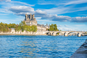 Beautiful view to Louvre museum over blue Seine river. Paris, France