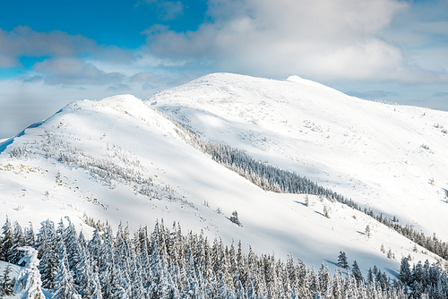 Winter landscape in mountains with snow and blue hills