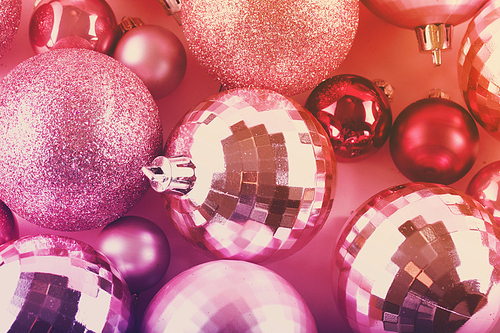Pink Christmas balls close up festive background, toned