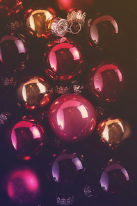 Dark Pink Christmas balls close up festive background, toned