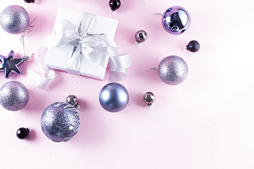 Gray Christmas decorations with gift box on pink background