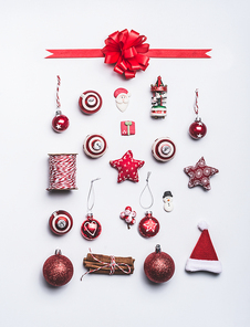 Christmas ornaments flat lay composition on white background, top view. Red Christmas decoration and gift wrapping and package objects , festive minimal pattern layout