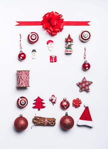 Christmas ornaments flat lay frame composition on white background, top view. Red Christmas decoration and gift wrapping and package objects , festive minimal layout
