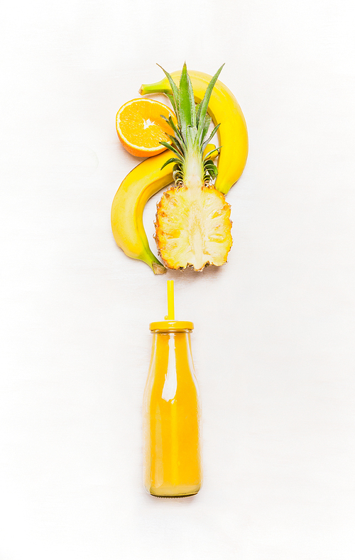 Yellow smoothie drink in bottle with straw  and fruits  ingredients ( banana, pineapple, orange)  on white wooden background, top view
