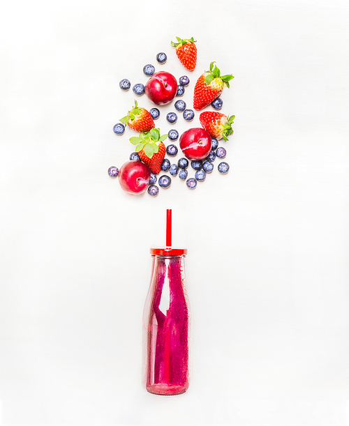 Red smoothie drink in bottle with straw  and fruits  berries ingredients on white wooden background, top view