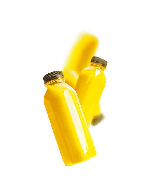 Flying yellow smoothie or juice bottle , isolated on white. Branding copy space