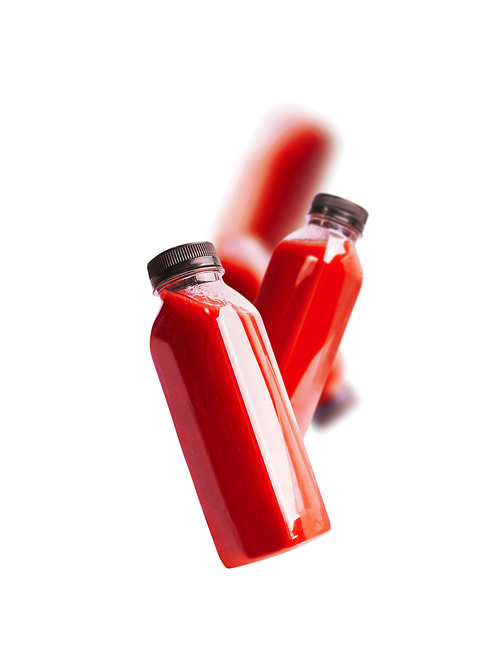 Flying red smoothie or juice bottle , isolated on white. Branding copy space