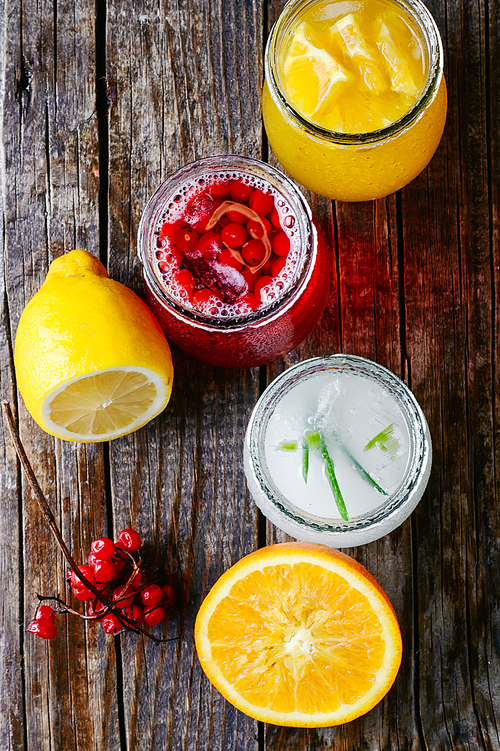 Freshly squeezed orange juice and citrus fruit in stylish glass jars