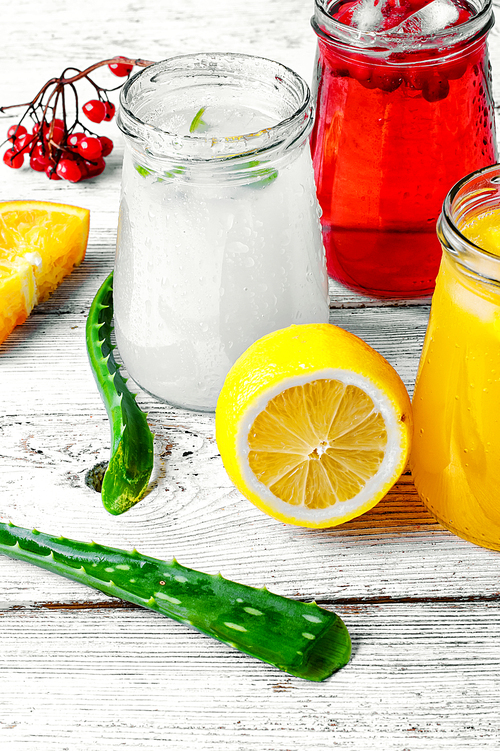 Freshly squeezed orange juice and citrus fruit in stylish glass jars