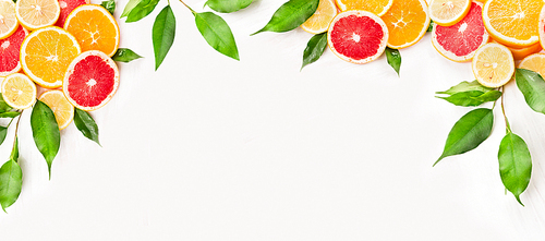 Citrus fruits slice with green leaves on white wooden background, banner for website
