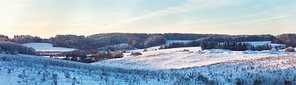 Panorama of Winter hills. Frozen meadow. Frost on trees