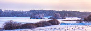 Winter evening on a lake. Frost, ice and snow in Belarus