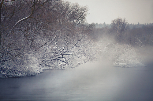 Misty winter river. Winter fog ober the river. Belarus