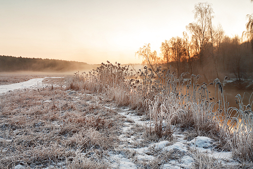 Winter misty dawn on the river. Rural foggy and frosty scene in Belarus