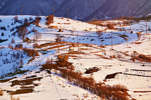 Early spring in mountains. Sunny rural winter scene. Winter panoramic aerial view landscape
