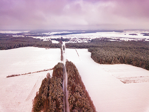 Winter countryside aerial view. landscape with fields, woodland, forest, meadow and village. Photography from a drone.