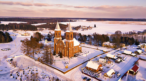 Aerial view of old Christian church. Rural winter scene. Village Rubezhevichi near Minsk, Belarus